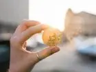 Bitcoin - moneta w dłoni