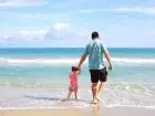 Bon 1000 zł na wakacje - ojciec z córką na plaży