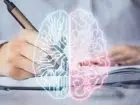Testy psychologiczne - grafika przestawiająca mózg człowieka na tle osoby piszącej w notatniku