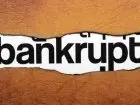 Napis "bankrupt" umieszczony na grafice na brązowym tle