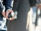 500 plus dla policjantów - osoba w mundurze trzymająca krótkofalówkę