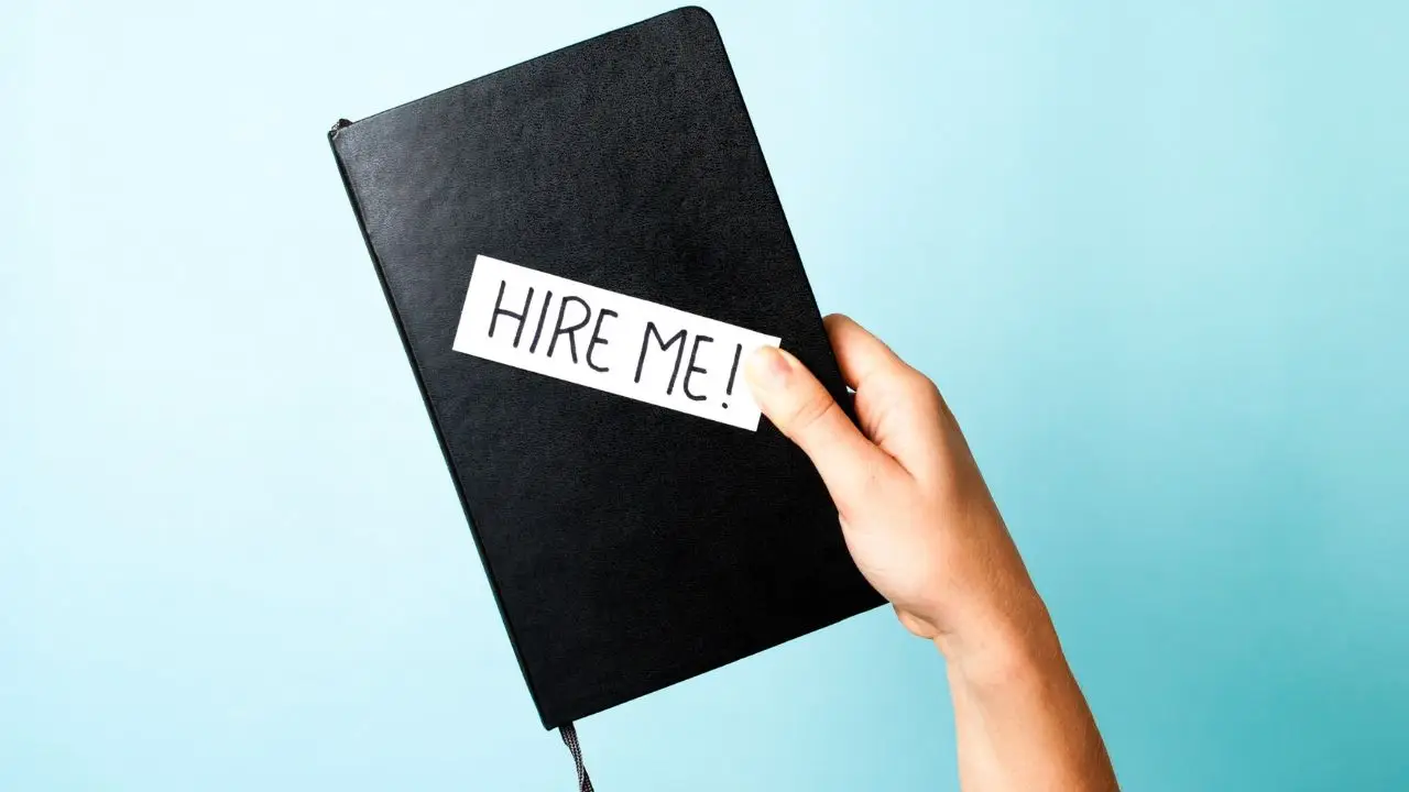 Czarny notes z napisem hire me