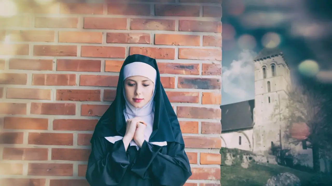 Emerytury zakonnic - zakonnica młoda uśmiechnięta przy murze