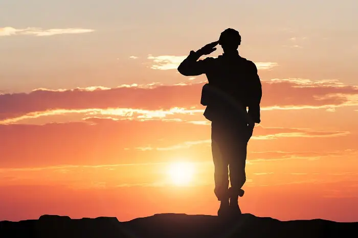 Życiorys do wojska - sylwetka salutującego żołnierza na tle zachodzącego słońca