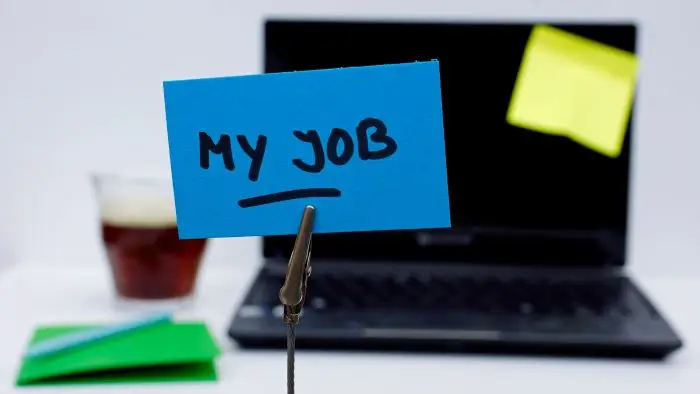 Kartka z napisem "my job" na tle laptopa