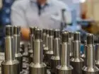 Planowanie produkcji - mężczyzna pracujący przy produkcji metalowych elementów