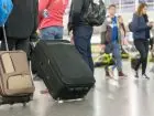 Coraz mniej Ukraińców chce zostać w Polsce - ludzie z walizkami, w trakcie podróży