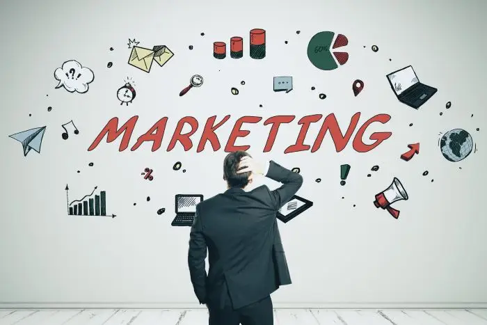 Mężczyzna stojący przed napisem marketing